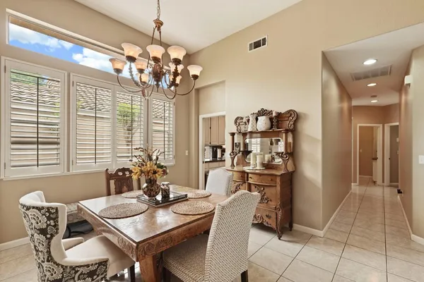 a view of a dining room with furniture and chandelier