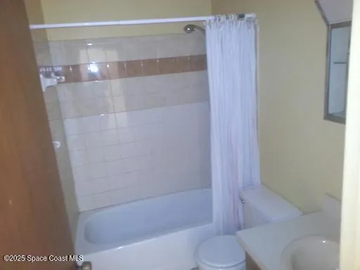 a bathroom with a shower and a toilet