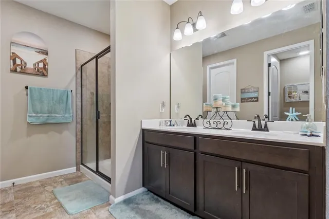 a bathroom with a shower and a sink