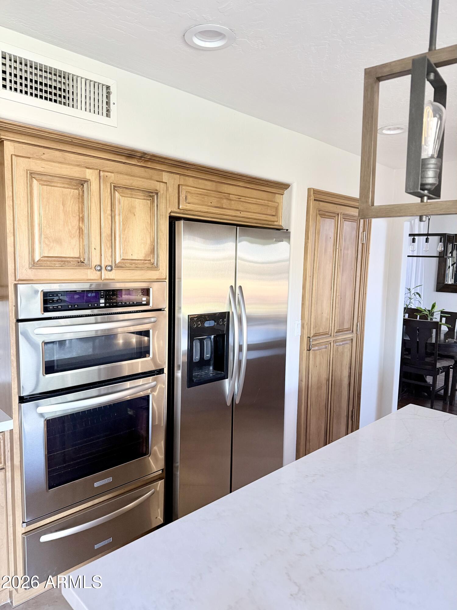 3426 East Clark Road Phoenix, AZ 85050 - Photo 13 of 48 a kitchen with stainless steel appliances granite countertop a refrigerator and a stove top oven