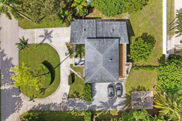 an aerial view of a house with a swimming pool