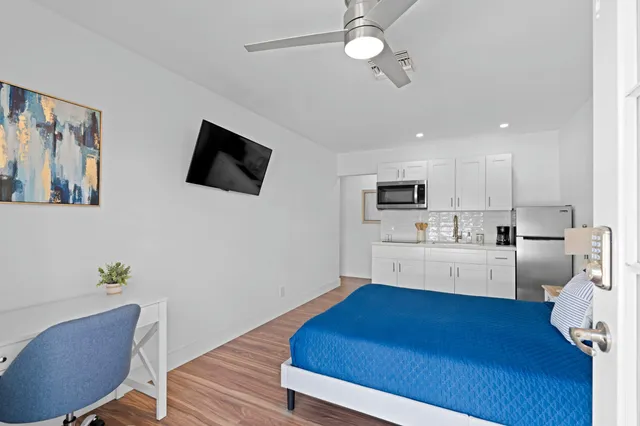 a kitchen with furniture wooden floor and a view of living room