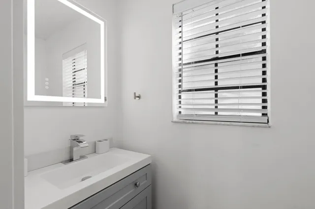 a bathroom with a sink and a window