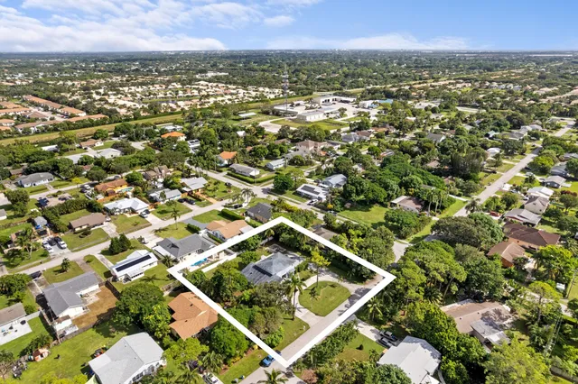 an aerial view of residential houses with outdoor space