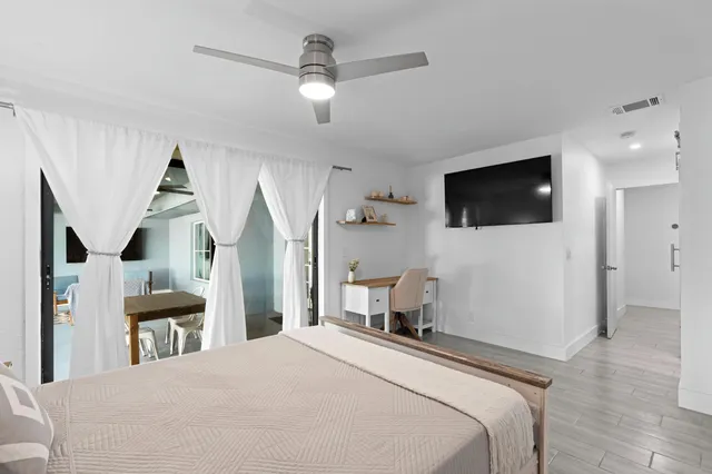 a bedroom with a bed and a flat screen tv