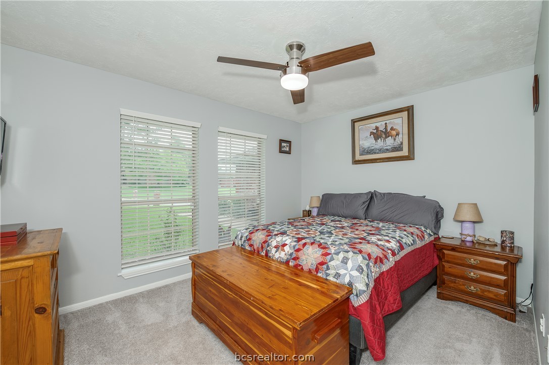 2009 Cobblestone Lane Bryan, TX 77807 - Photo 16 of 23 a bedroom with a bed and a chandelier