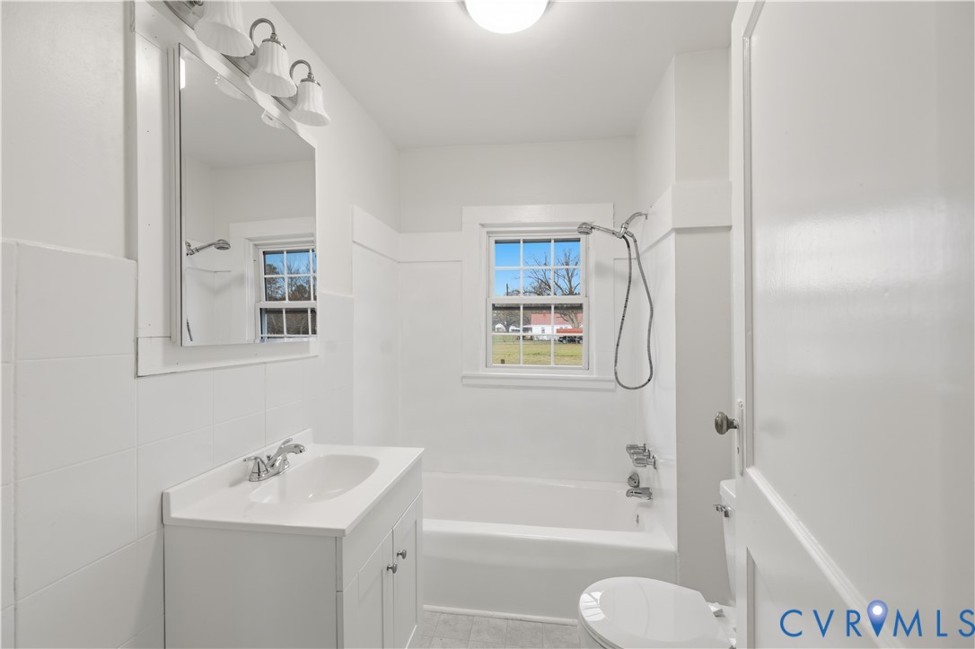 239 Brunswick Road Emporia, VA 23847 - Photo 13 of 24 White vanity with integrated sink, chrome faucet,