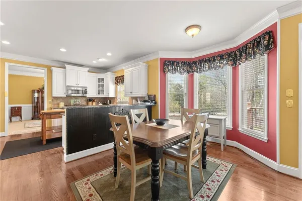 a view of a dining room with furniture window and wooden floor