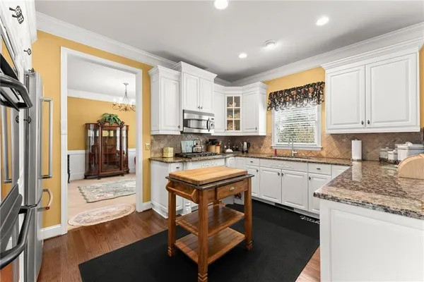 a kitchen with a stove a sink and a refrigerator