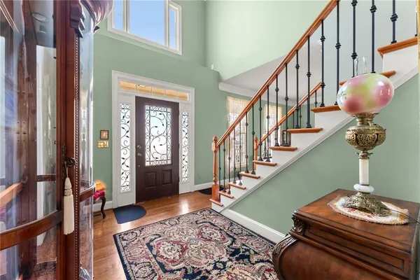 a living room with stairs and a rug