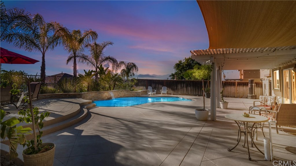9397 Golden Lantern Road Riverside, CA 92508 - Photo 1 of 1 a swimming pool with outdoor seating and plants