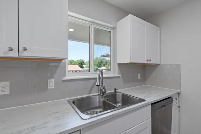 a kitchen with a sink and cabinets