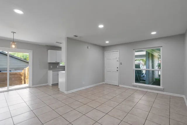 wooden floor in an empty room with a kitchen