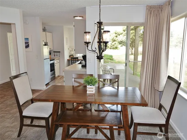 a view of a porch with furniture and a yard