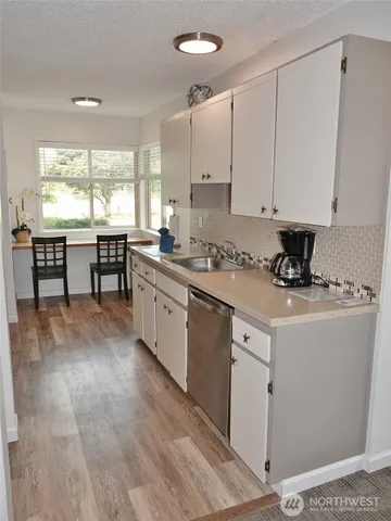 a view of a room with furniture and windows