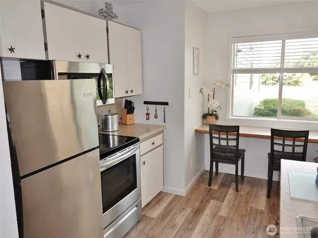 a kitchen with a refrigerator stove and cabinets