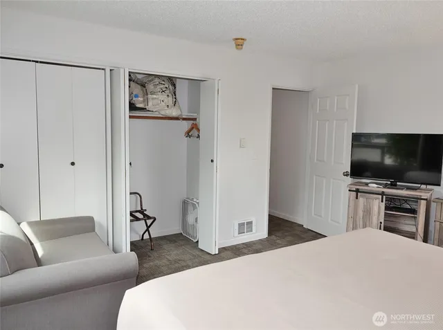 a bathroom with a granite countertop sink a toilet and a mirror