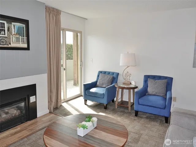 a living room with furniture a rug and a window