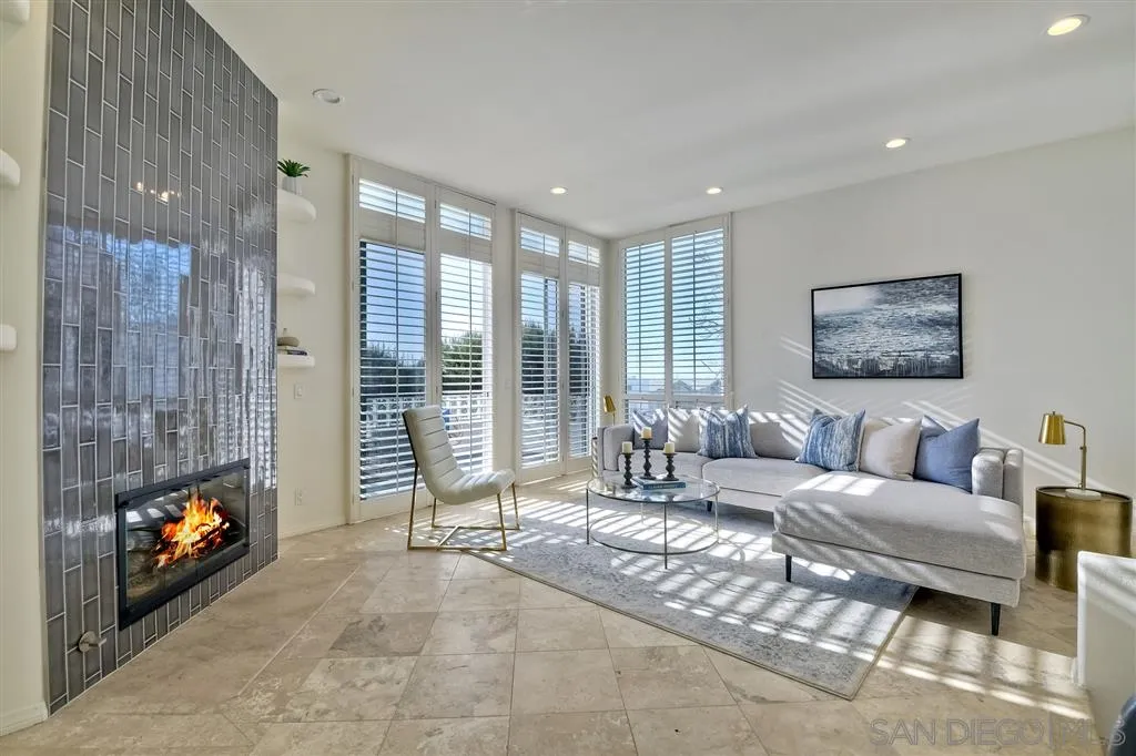 2136 Glasgow Avenue Cardiff, CA 92007 - Photo 4 of 25 a living room with furniture a flat screen tv and a fireplace