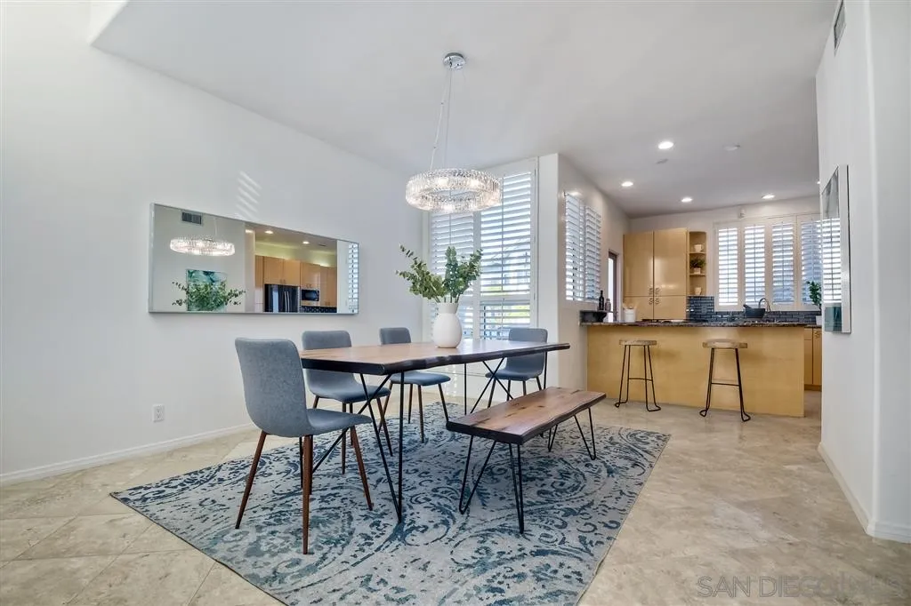 2136 Glasgow Avenue Cardiff, CA 92007 - Photo 8 of 25 a living room with dining table and a wooden floor