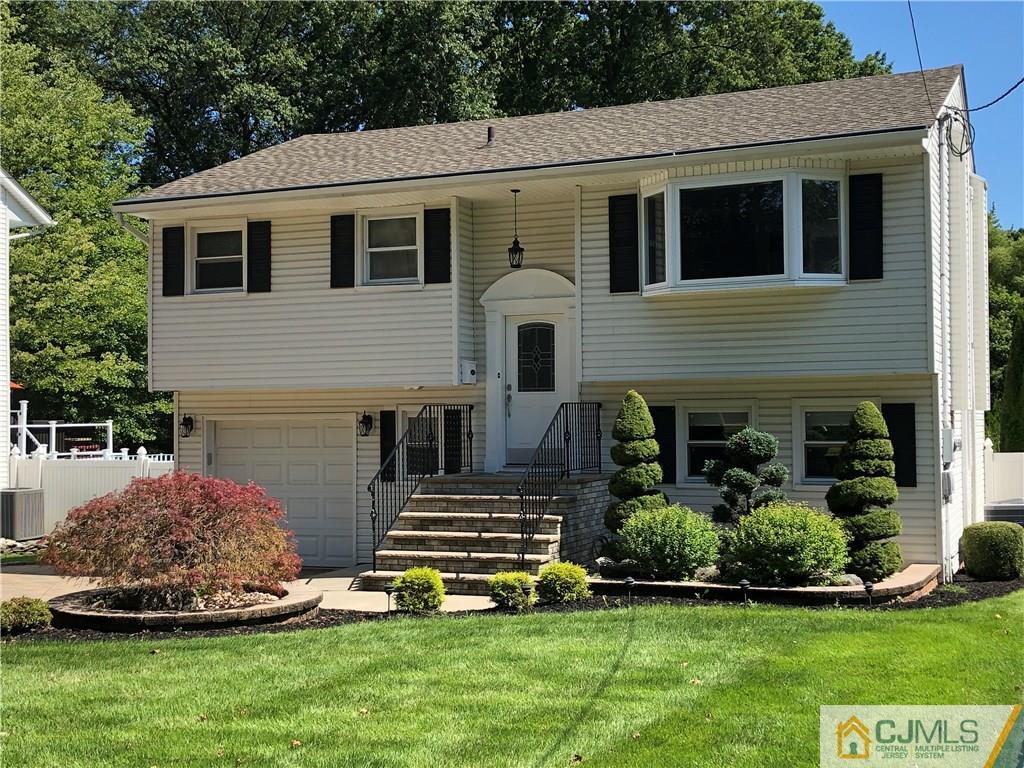 144 Kimberly Road Colonia, NJ 07067 - Photo 1 of 27 a front view of a house with a yard and trees
