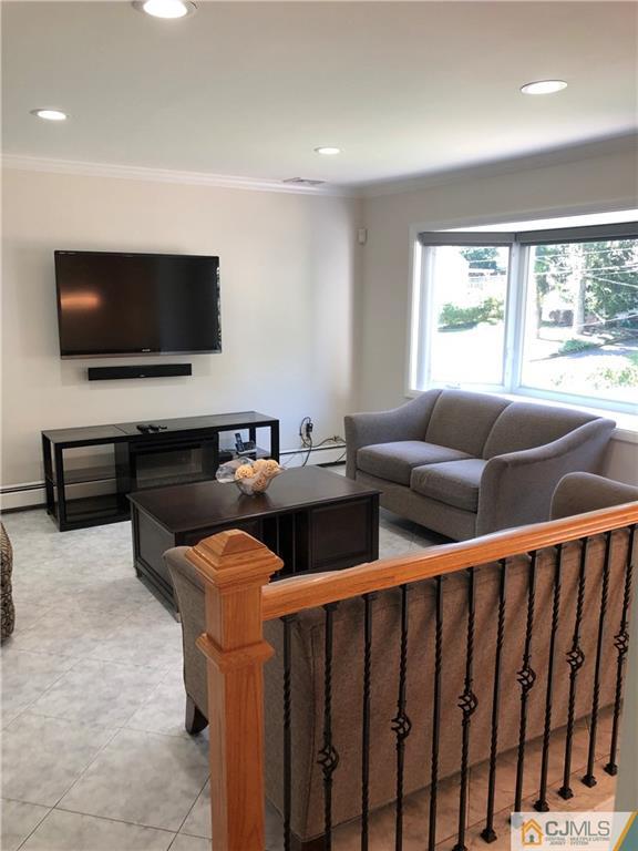 144 Kimberly Road Colonia, NJ 07067 - Photo 2 of 27 a living room with furniture and a flat screen tv
