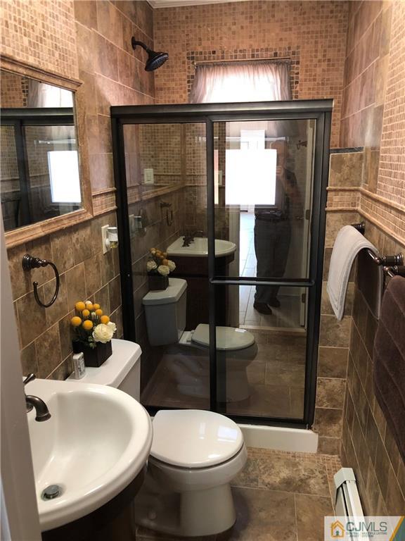 144 Kimberly Road Colonia, NJ 07067 - Photo 12 of 27 a bathroom with a sink toilet and shower