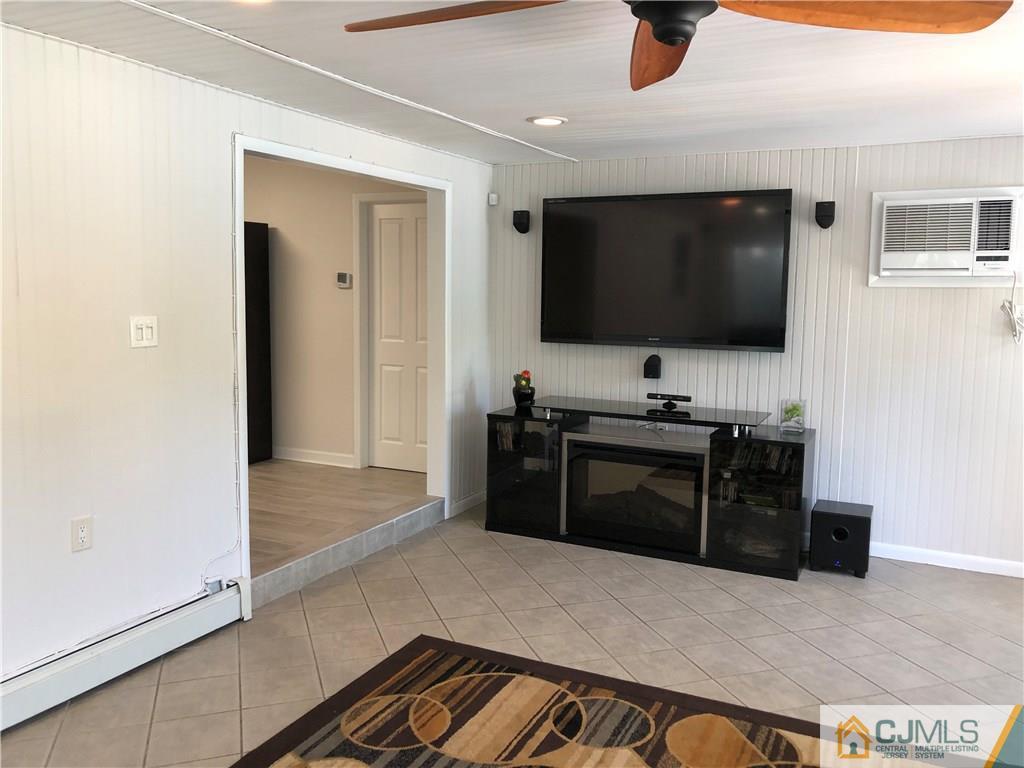 144 Kimberly Road Colonia, NJ 07067 - Photo 13 of 27 a living room with furniture and a flat screen tv