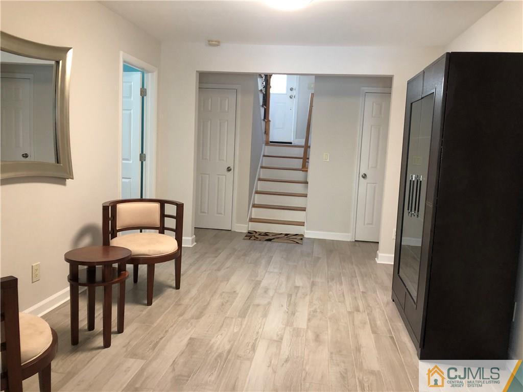 144 Kimberly Road Colonia, NJ 07067 - Photo 15 of 27 a view of a room with wooden floor lounge chair and windows