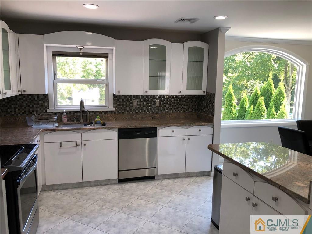 144 Kimberly Road Colonia, NJ 07067 - Photo 8 of 27 a kitchen that has a sink and a stove