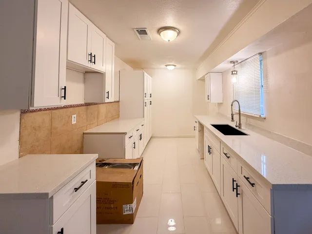 a bathroom with a sink vanity granite and toilet