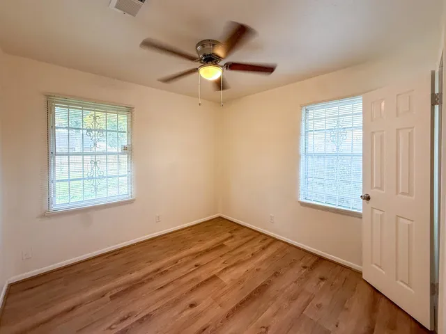 a view of a yard with large trees