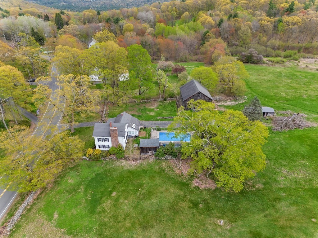 175 Brimfield Road Monson, MA 01057 - Photo 11 of 41 a backyard of a building with lawn chairs and wooden fence