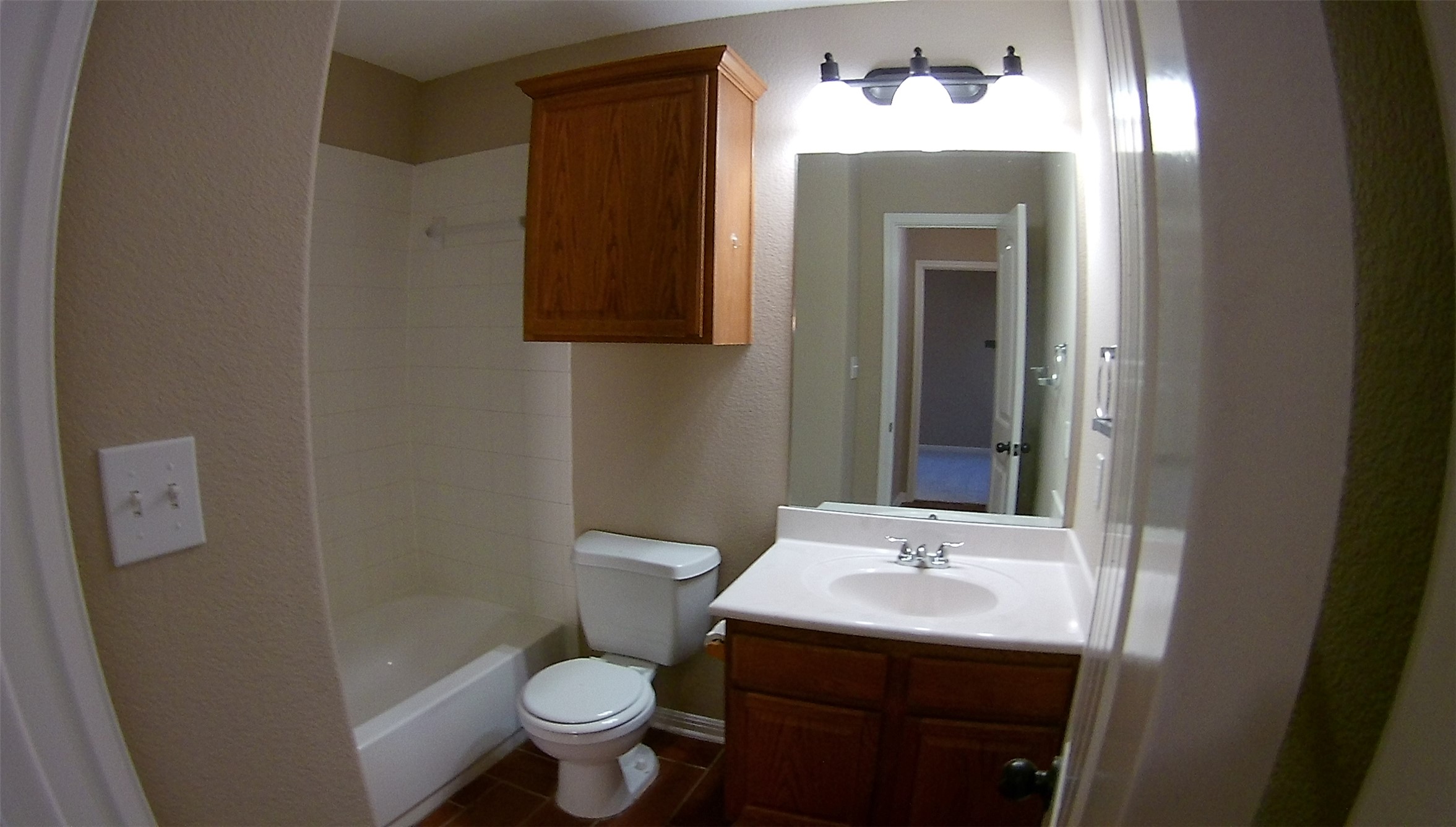 3304 Wickham Lane Austin, TX 78725 - Photo 8 of 13 Full bathroom with vanity, washtub / shower combination, and a textured wall