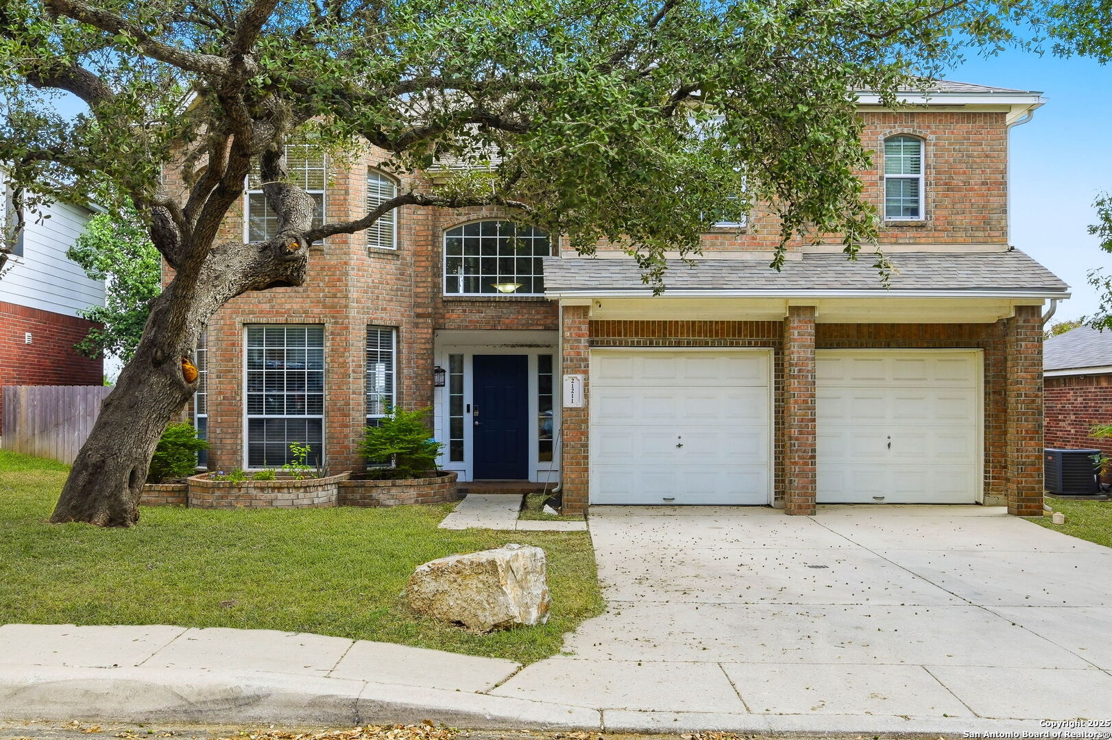21211 Rio Sabinal San Antonio, TX 78259 - Photo 1 of 31 a view of a white house with a small yard and large tree