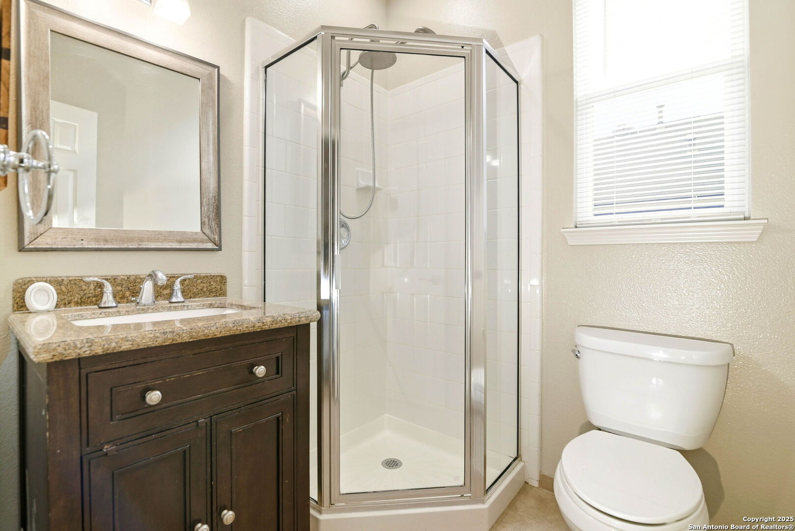 21211 Rio Sabinal San Antonio, TX 78259 - Photo 12 of 31 a bathroom with a granite countertop sink toilet and shower