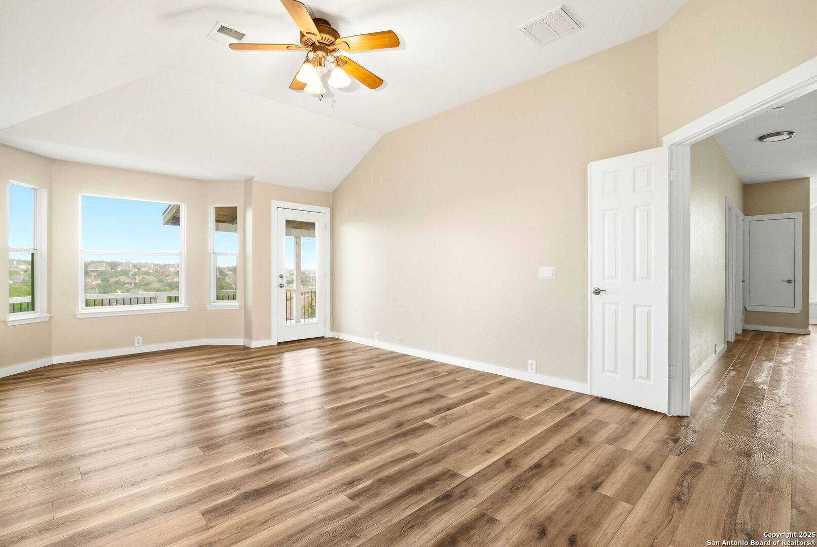 21211 Rio Sabinal San Antonio, TX 78259 - Photo 13 of 31 a view of an empty room with wooden floor and a window