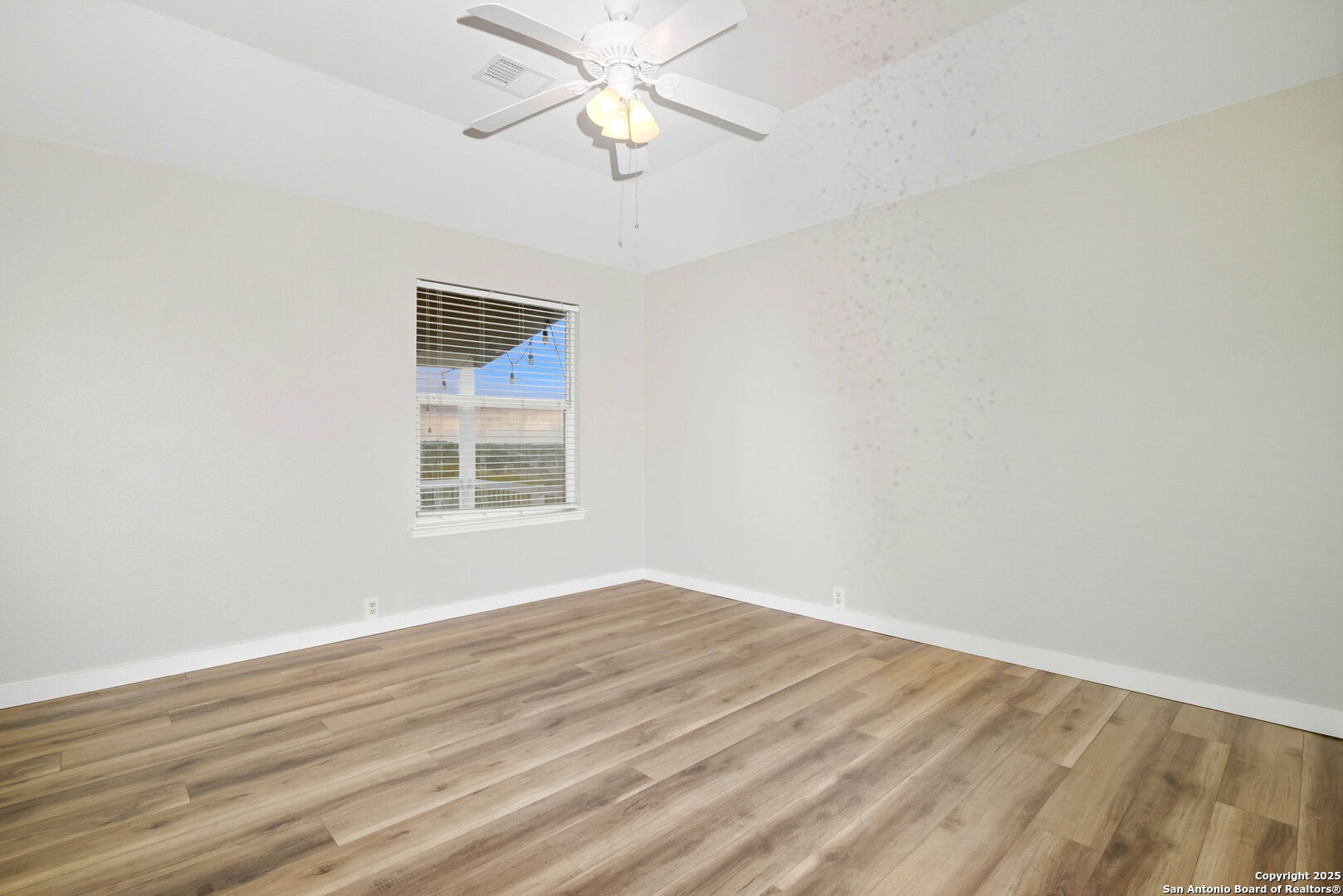 21211 Rio Sabinal San Antonio, TX 78259 - Photo 20 of 31 a view of an empty room with wooden floor and a window