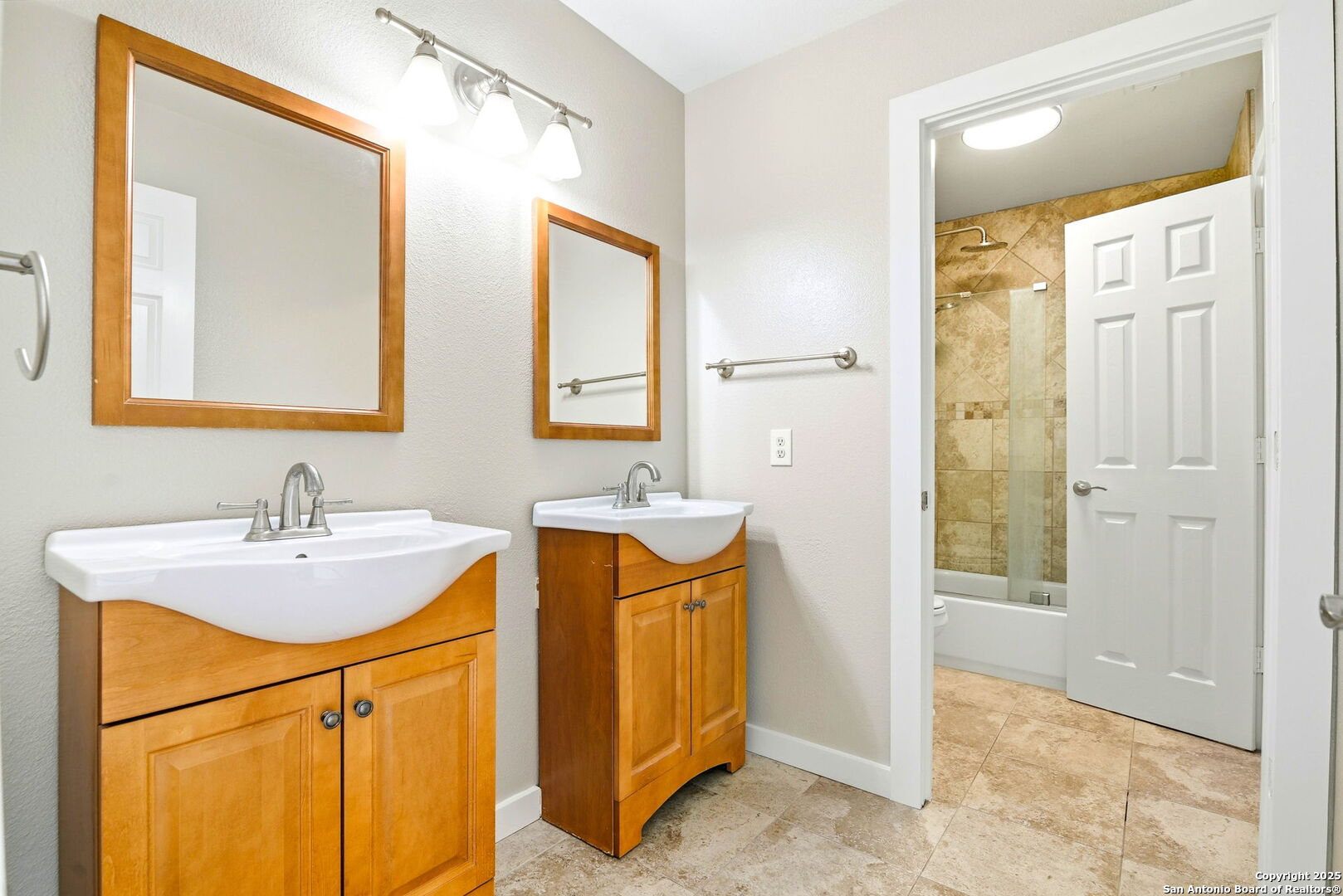 21211 Rio Sabinal San Antonio, TX 78259 - Photo 21 of 31 a bathroom with a sink a mirror and a shower