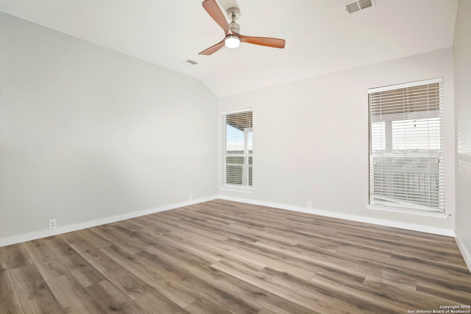 21211 Rio Sabinal San Antonio, TX 78259 - Photo 22 of 31 a view of an empty room with wooden floor and a window