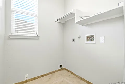 a view of a small space with a window and a fan