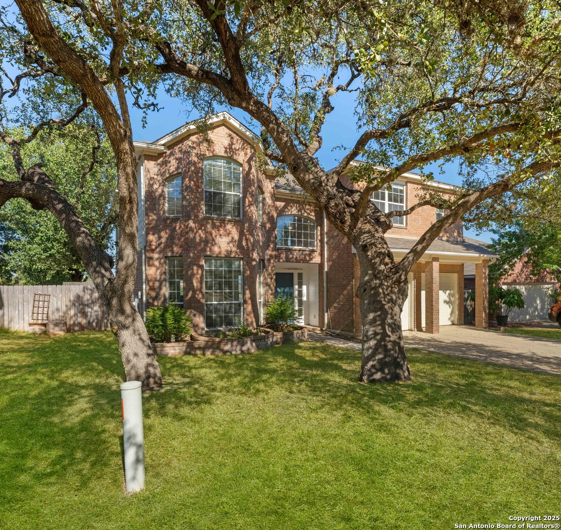 21211 Rio Sabinal San Antonio, TX 78259 - Photo 29 of 31 a front view of a house with a yard