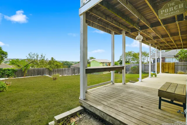 a view of a deck with a big yard