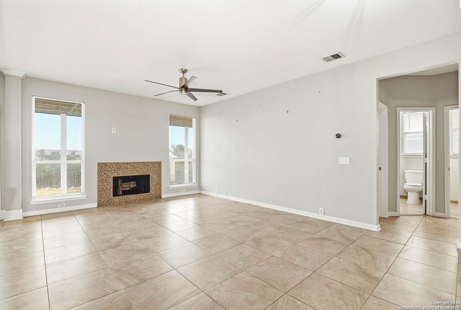 21211 Rio Sabinal San Antonio, TX 78259 - Photo 9 of 31 a view of an empty room with a fireplace and a window