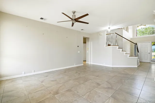 a view of a livingroom with a ceiling fan and window