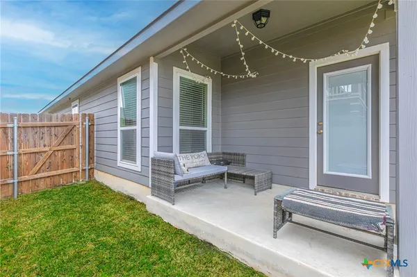 a view of a house with backyard and a patio
