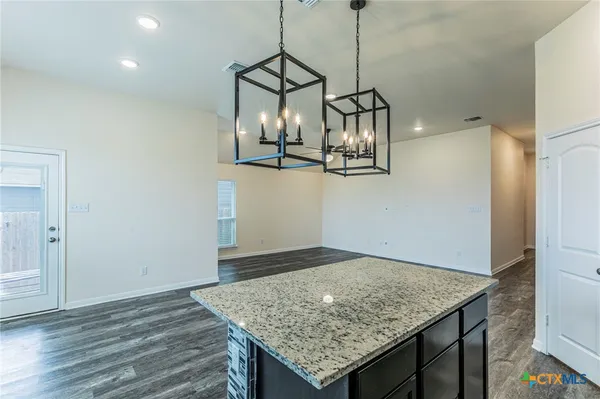 a view of a kitchen counter space and wooden floor
