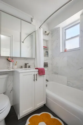 a bathroom with a sink toilet and shower