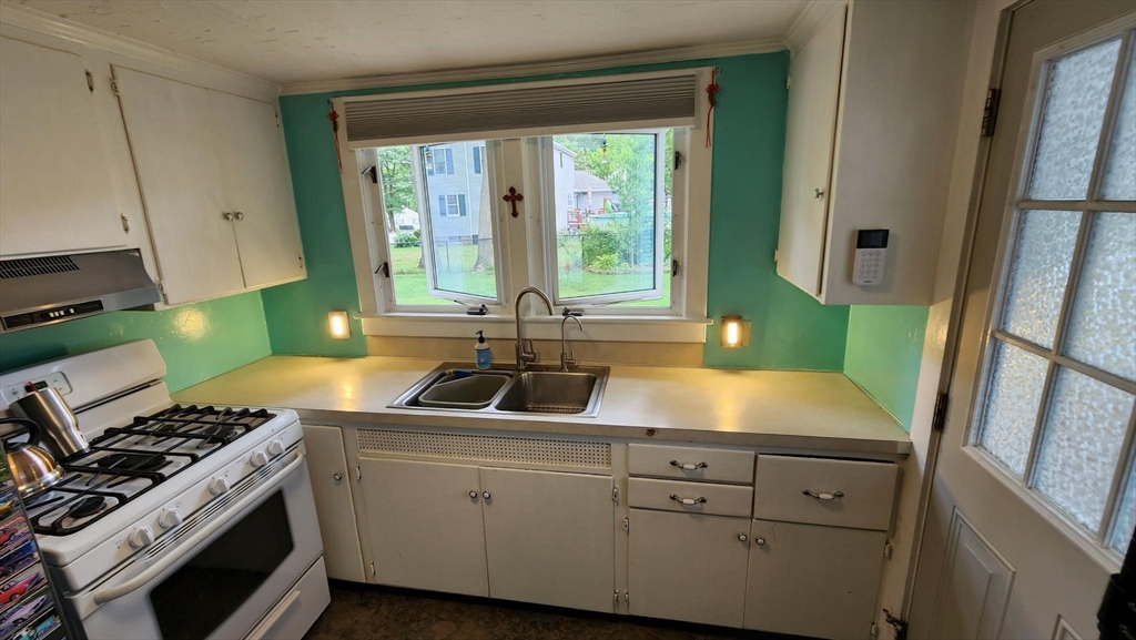 4 Fuller Road Attleboro, MA 02703 - Photo 3 of 16 a kitchen with a sink stove and cabinets