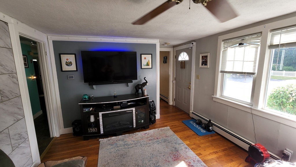 4 Fuller Road Attleboro, MA 02703 - Photo 5 of 16 a living room with window furniture and a flat screen tv